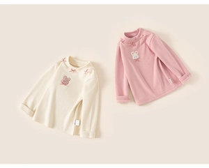 Detail van kindertops met opstaande kraag, roze strikjes en pluche konijn borduurwerk