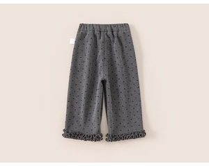 Close-up of gray girls' fleece trousers with heart patterns and ruffle hem detail