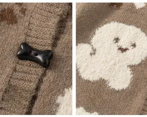 Detail of a brown knit cardigan featuring bone-shaped toggle buttons and cute cartoon patterns