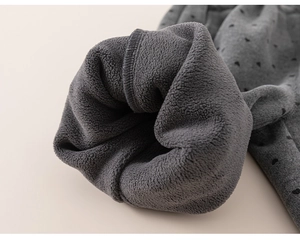 Close-up of girls grey thermal pants with black heart pattern and thick fleece lining