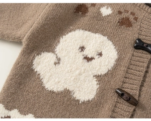 Detail of coffee brown knit cardigan with plush ghost patch and bone-shaped button