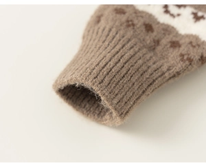 Detailed macro view of the ribbed cuffs and wool-like texture on a brown knitted cardigan