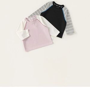 Detail of baby raglan long sleeve T-shirts showing cotton fabric and ribbed cuffs