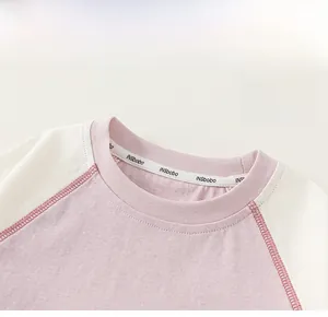 Detail of child's contrast raglan sleeve T-shirt with premium stitched crew neckline