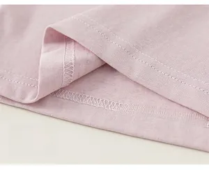 Detail shot of the double-needle stitching and hem on the pink cotton striped shirt