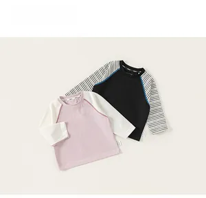 Detail of soft cotton kids long sleeve t-shirts with raglan sleeves and round collar