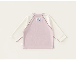 Detail of children striped raglan sleeve shirt with pink and beige cotton fabric