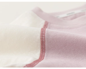 Detailed close-up of premium stitching on striped cotton long-sleeved kids T-shirt