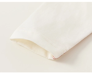 Close-up of double-stitched cuffs on a soft cotton striped long sleeve t-shirt
