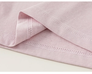 Close-up of pink striped cotton shirt showing double-stitched hem and soft fabric texture