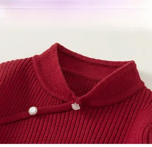 Close-up of red knit sweater with Chinese stand collar and pearl button details