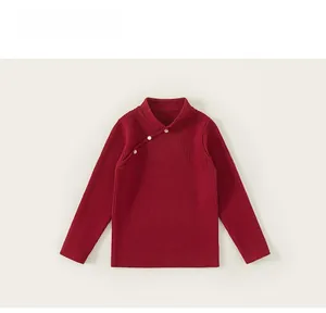 Detail view of red Chinese style knit sweater showing mandarin collar and pearl buttons