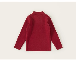 Macro detail of the red vertical ribbed knit fabric and texture on the children's sweater