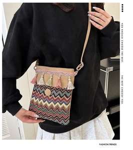Ethnic style tassel crossbody bag shown on model highlighting the size and strap length