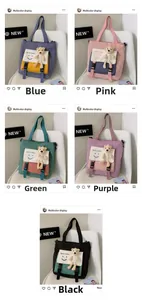 Detail view of canvas tote bags with smile print and cute teddy bear charms in five colors