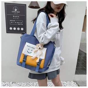 Detail of canvas tote with Hello Baby print and cute 3D plush bear keychain accessory