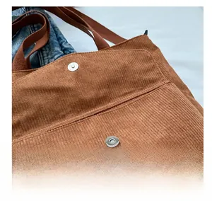 Detail shot of caramel brown corduroy fabric with high-quality metal magnetic closure