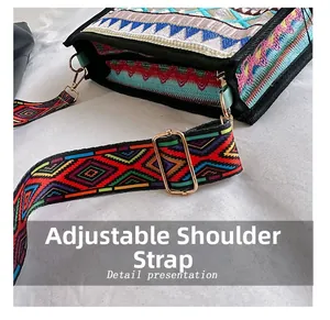 Detail view of ethnic style embroidered shoulder strap with adjustable gold metal buckle