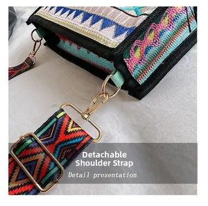 Macro detail of bohemian embroidery and gold metal lobster clasp on the shoulder bag strap