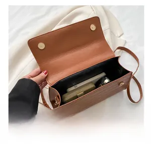 Internal view of brown textured crossbody bag showing spacious capacity for phone and wallet