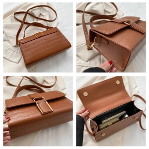 Detail view of brown crocodile texture handbag showing back, side, front and inner storage