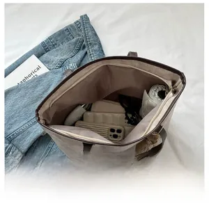 Top view of large grey tote bag showing spacious interior with phone umbrella and wallet