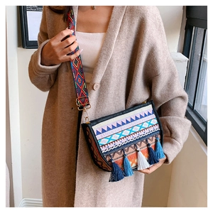 Close-up of ethnic crossbody bag with colorful embroidery and multi-colored fringe tassels