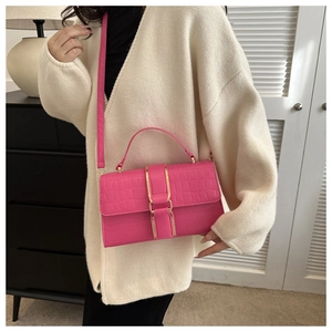 Detail view of rose pink crocodile pattern small square bag with gold metal buckle