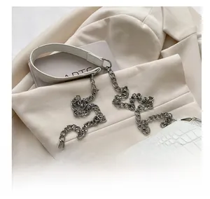 Close-up of comfortable shoulder strap with silver metal chain and white crocodile texture