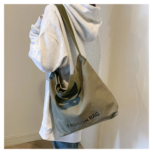 Detail view of army green canvas tote bag showing soft texture and side structure design