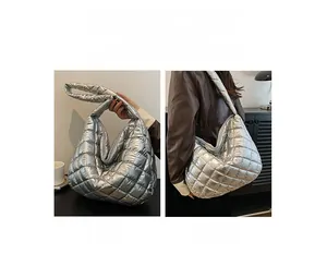 Silver quilted tote bag showing two carrying styles as a handbag and shoulder bag