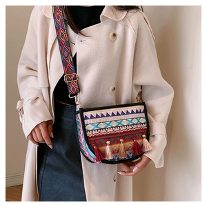 Ethnic style embroidered saddle bag with colorful tassels and wide adjustable strap