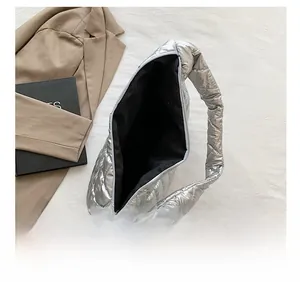 Macro view of spacious interior in silver quilted tote bag with black lining
