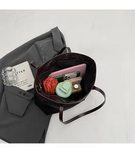 Deep brown woven tote bag interior showing capacity for tablet, umbrella, and daily essentials