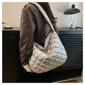 Silver quilted oversized tote bag shown on a model side view for casual daily wear