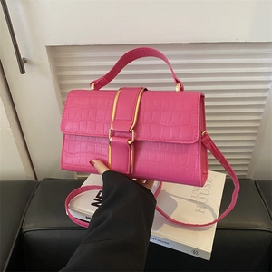Pink crocodile pattern shoulder bag with a gold buckle and adjustable strap