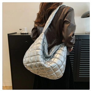 Detailed back view of a large silver quilted tote bag with metallic rhombic stitching