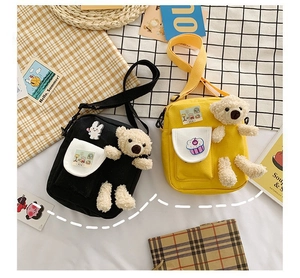 Gros plan de sacs bandoulière en toile avec ours en peluche 3D et patchs de dessins