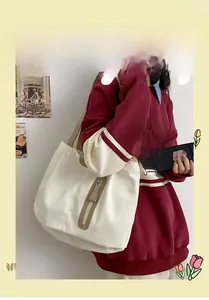 Canvas tote bag in beige with brown shoulder straps worn by model for casual style