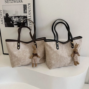 Classic large capacity tote bag with vintage leather texture and cute rabbit charm detail