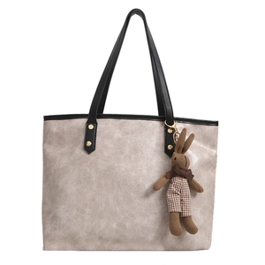 Large cream cracked leather tote bag with black trim and checkered bunny charm