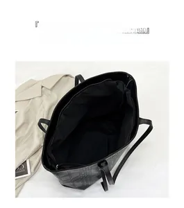 Detail view of the spacious black checkered tote bag interior with zipper pocket