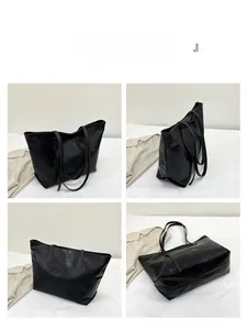 Detail view of black embossed tote bag showing front, side, back and bottom angles