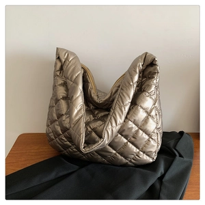 Detail of metallic quilted tote bag with diamond stitching and soft padded texture