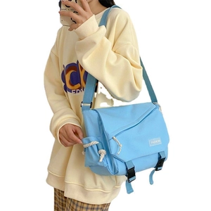 Light blue messenger bag for women with flap buckle closure and adjustable strap