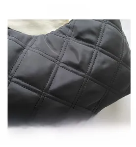 Close-up of the black quilted fabric with a glossy rhombus pattern on this stylish handbag