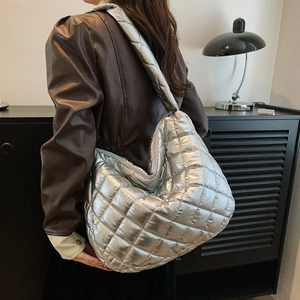 Metallic silver quilted crossbody tote bag with large capacity and wide shoulder strap