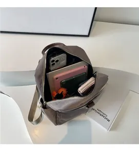 Top view of spacious grey backpack interior with tablets and daily essentials organized