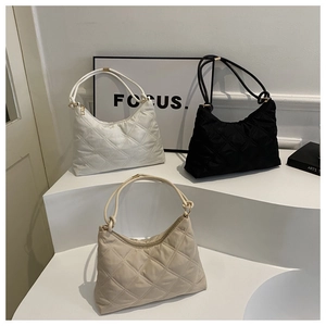 Three quilted rhombic bags in white, black, and beige with rope handles and gold rings
