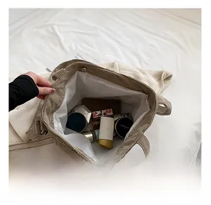 Spacious beige corduroy tote interior with metal magnetic closure and organizing pockets